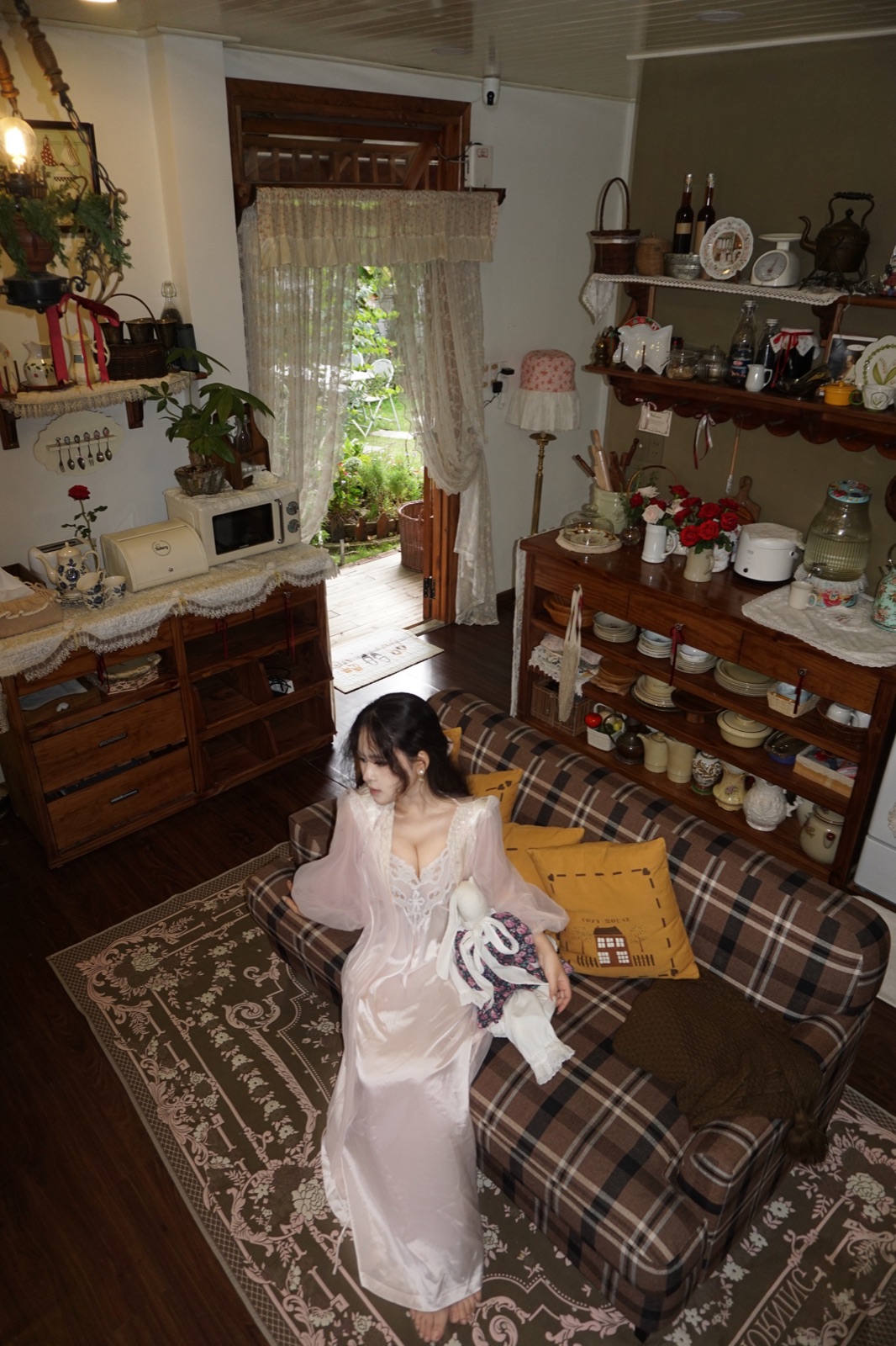 Clara seated in a romantic country cottage