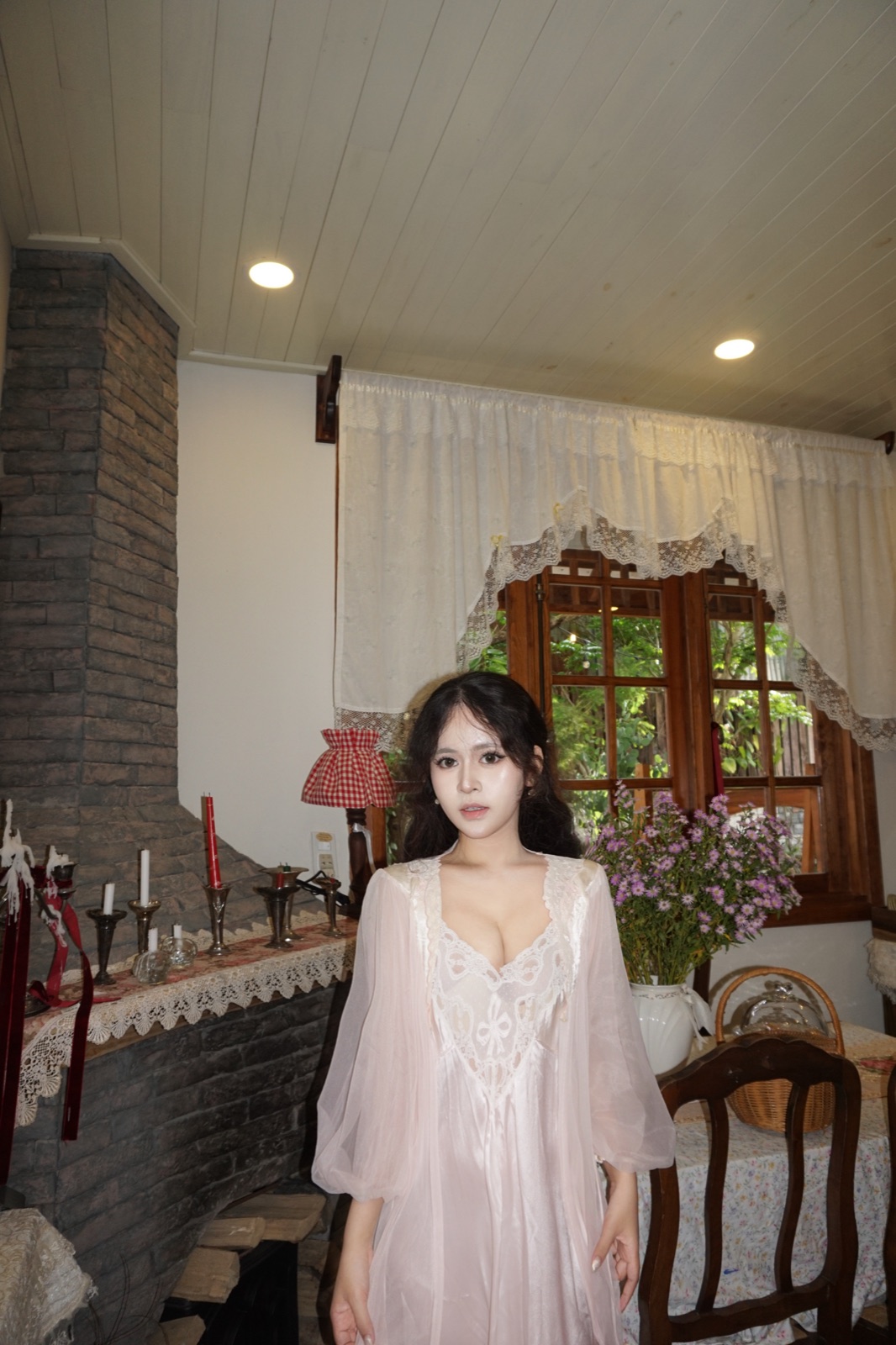 Clara in a pale dress inside a romantic country house