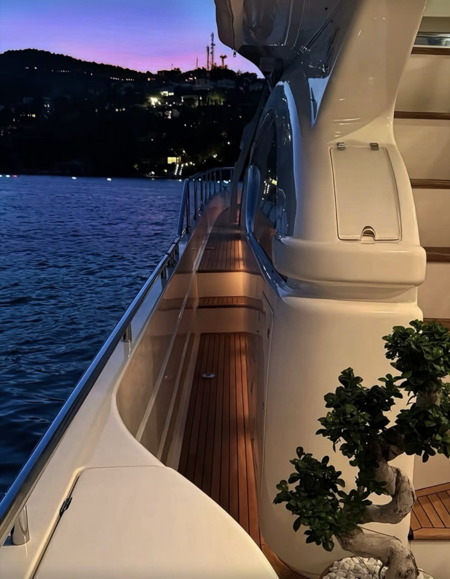 The illuminated deck of a yacht at dusk